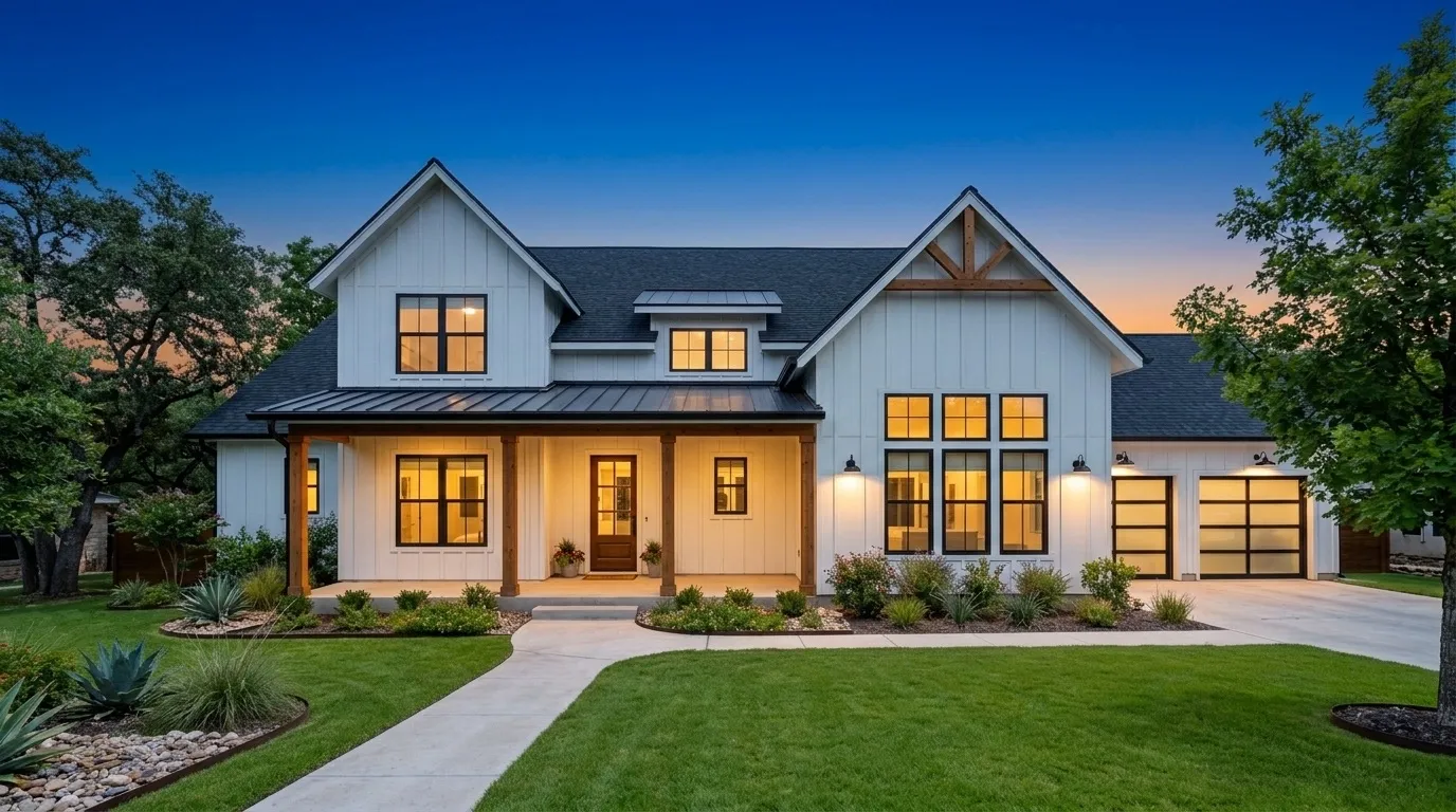 Farmhouse exterior at twilight with the windows lit